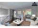 Bright living room with neutral walls, modern furniture, and stylish rug leading into the dining area at 5340 The Savoy St, Atlanta, GA 30349
