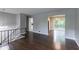 Open-concept living room featuring hardwood floors and seamless access to dining area at 5340 The Savoy St, Atlanta, GA 30349