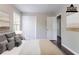 Staged main bedroom featuring neutral colors, a closet, and a view to the en-suite bathroom at 5340 The Savoy St, Atlanta, GA 30349