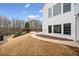 Landscaped backyard with a concrete path and white home exterior at 401 Nichols Dr, Suwanee, GA 30024