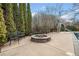 Backyard with beautiful landscaping, pool slide, and a stone fire pit with seating at 401 Nichols Dr, Suwanee, GA 30024