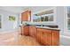 Spacious home wet bar area with stainless steel refrigerator and wood cabinets at 401 Nichols Dr, Suwanee, GA 30024