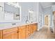 Bathroom with double vanity, wood cabinets, and tiled floors at 401 Nichols Dr, Suwanee, GA 30024