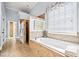Relaxing bathroom featuring a soaking tub and a tiled shower at 401 Nichols Dr, Suwanee, GA 30024