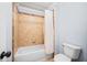 Cozy bathroom featuring tub-shower combo with decorative tile and neutral paint at 401 Nichols Dr, Suwanee, GA 30024