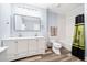Bathroom featuring a double sink vanity, tub, shower, and modern finishes at 401 Nichols Dr, Suwanee, GA 30024