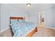 Bright bedroom featuring plush carpet, neutral paint, and view to ensuite bathroom at 401 Nichols Dr, Suwanee, GA 30024
