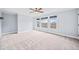 Spacious bonus room with neutral carpet, ceiling fan, and triple windows providing plenty of natural light at 401 Nichols Dr, Suwanee, GA 30024