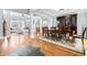 Bright dining area featuring an elegant dining set, hardwood floors, and views into the adjacent living room at 401 Nichols Dr, Suwanee, GA 30024