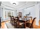 Elegant dining room with a large table, hardwood floors, and a bright window view at 401 Nichols Dr, Suwanee, GA 30024