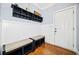 Mudroom area with custom shelving, bench seating, hooks, and hardwood floors by the front door at 401 Nichols Dr, Suwanee, GA 30024