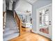 Entryway into home with wooden staircase and view into the living room and access to the backyard at 401 Nichols Dr, Suwanee, GA 30024