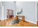 Bright foyer featuring a wood door with glass panels, hardwood floors, and decor on a wooden console table at 401 Nichols Dr, Suwanee, GA 30024
