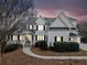 Charming front exterior showcases a two-story home with manicured landscaping, stone accents, and a covered front porch at 401 Nichols Dr, Suwanee, GA 30024