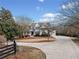 Exterior showcases a beautiful home with a long driveway, fenced yard and lush landscaping for a picturesque setting at 401 Nichols Dr, Suwanee, GA 30024
