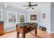 Finished basement with a foosball table, and a view of the pool out the window at 401 Nichols Dr, Suwanee, GA 30024