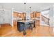 Bright kitchen with island, granite counters, stainless appliances, and hardwood floors at 401 Nichols Dr, Suwanee, GA 30024