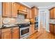Gourmet kitchen featuring stainless steel appliances, stone backsplash, and ample cabinet space at 401 Nichols Dr, Suwanee, GA 30024
