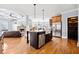 Open-concept kitchen features a large island, stainless steel appliances, and hardwood floors at 401 Nichols Dr, Suwanee, GA 30024