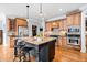 Open kitchen featuring a large island, stainless steel appliances, and hardwood floors at 401 Nichols Dr, Suwanee, GA 30024