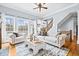 Comfortable living room with hardwood floors, large windows, and cozy couches with decorative pillows at 401 Nichols Dr, Suwanee, GA 30024
