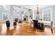 Spacious living room with hardwood floors, a stone fireplace, built-in shelving, and coffered ceilings at 401 Nichols Dr, Suwanee, GA 30024