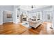 Inviting living room with hardwood floors, a stone fireplace, and custom built-in bookshelves at 401 Nichols Dr, Suwanee, GA 30024