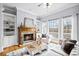 Cozy living room features a stone fireplace, built-in bookshelves, and large windows for natural light at 401 Nichols Dr, Suwanee, GA 30024