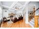 Open living room with a fireplace, coffered ceilings, hardwood floors, and staircase access to the second floor at 401 Nichols Dr, Suwanee, GA 30024