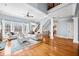 Elegant living room with hardwood floors, a ceiling fan, and comfortable seating under large windows at 401 Nichols Dr, Suwanee, GA 30024