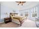 Spacious primary bedroom with vaulted ceiling, neutral carpet, and double windows for ample natural light at 401 Nichols Dr, Suwanee, GA 30024