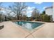 Backyard pool with slide, diving board, and patio is an ideal place for entertaining at 401 Nichols Dr, Suwanee, GA 30024