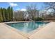 Large backyard pool with stone trim, slide, and well-maintained landscaping at 401 Nichols Dr, Suwanee, GA 30024