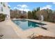 Beautiful backyard pool with a diving board, slide, fire pit, and lounge seating at 401 Nichols Dr, Suwanee, GA 30024