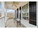 Inviting porch featuring stone flooring, classic black shutters, and cozy wrought-iron furniture at 401 Nichols Dr, Suwanee, GA 30024