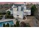 An aerial view of the rear exterior with a pool and patio area, perfect for outdoor relaxation and entertaining guests at 401 Nichols Dr, Suwanee, GA 30024