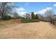 A large private yard with established landscaping, trees, and a fence at 401 Nichols Dr, Suwanee, GA 30024