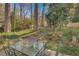 Picturesque backyard patio with an outdoor dining set, surrounded by greenery and mature trees at 491 Princeton Ne Way, Atlanta, GA 30307