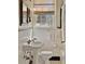 Elegant bathroom with pedestal sink, white tile, and decorative accents at 491 Princeton Ne Way, Atlanta, GA 30307