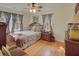 Bedroom features a wood bed frame, two windows with coverings, and hardwood floors at 491 Princeton Ne Way, Atlanta, GA 30307