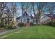 Charming home with a well-manicured lawn and mature trees surrounding the property at 491 Princeton Ne Way, Atlanta, GA 30307
