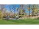 Community playground with various play structures surrounded by green space and trees at 491 Princeton Ne Way, Atlanta, GA 30307