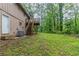 Home featuring an expansive backyard with lush greenery, deck, and stairs at 5802 Oakleaf Dr, Stone Mountain, GA 30087