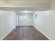 Finished basement with wood-look floors, neutral paint, and ample natural light from a window at 5802 Oakleaf Dr, Stone Mountain, GA 30087