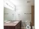 Well-lit bathroom with double sinks, large mirror, and a toilet at 5802 Oakleaf Dr, Stone Mountain, GA 30087