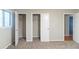 Carpeted bedroom featuring an open closet and view to the hall at 5802 Oakleaf Dr, Stone Mountain, GA 30087