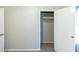 Bedroom showing an open closet with a clothes rod at 5802 Oakleaf Dr, Stone Mountain, GA 30087