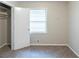 Carpeted bedroom with a window and an open closet with shelving at 5802 Oakleaf Dr, Stone Mountain, GA 30087