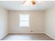 Bedroom featuring a window with blinds and neutral carpeting at 5802 Oakleaf Dr, Stone Mountain, GA 30087