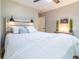 Bright bedroom featuring a wooden headboard with sconces and a cozy white comforter at 955 Coleman Sw St, Atlanta, GA 30310